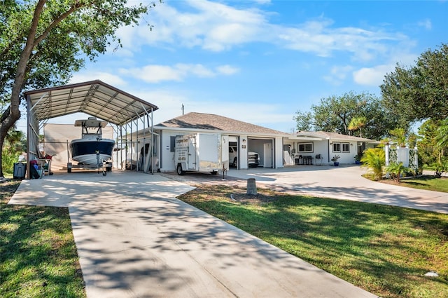 view of front of property with a carport and a front lawn