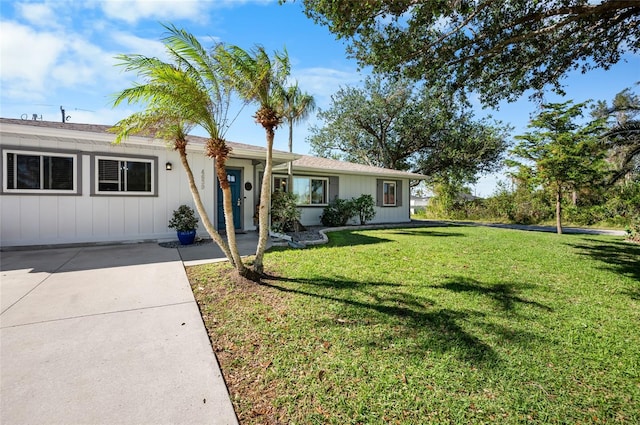 ranch-style home featuring a front yard