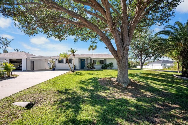 ranch-style home featuring a garage and a front lawn