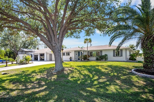 ranch-style home with a garage and a front lawn