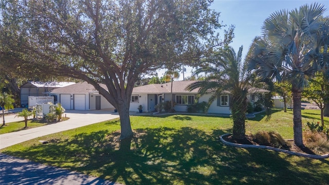 ranch-style house with a garage and a front lawn