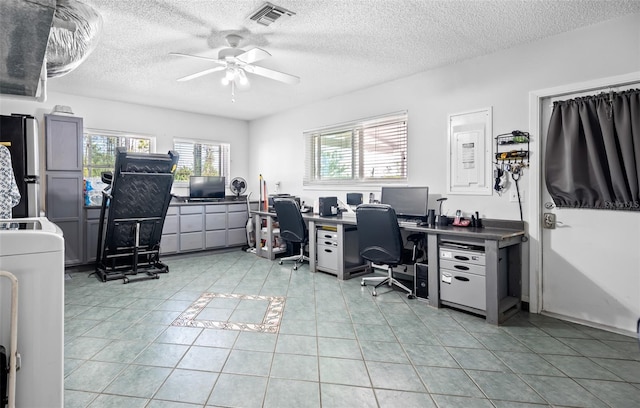 tiled home office with a textured ceiling and ceiling fan