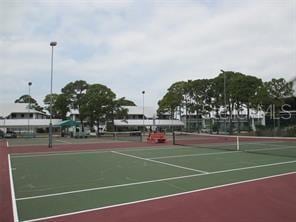 view of tennis court featuring basketball court