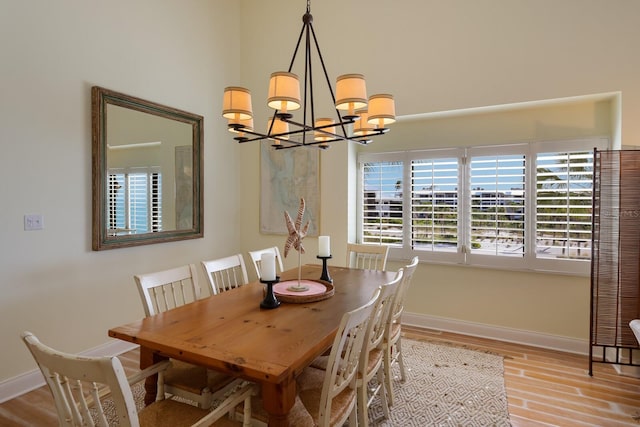 dining space featuring a notable chandelier and light hardwood / wood-style floors