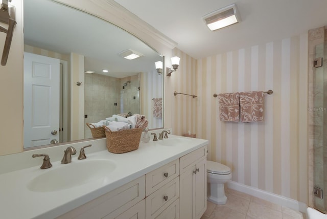 bathroom with toilet, vanity, tile patterned floors, and a shower with shower door