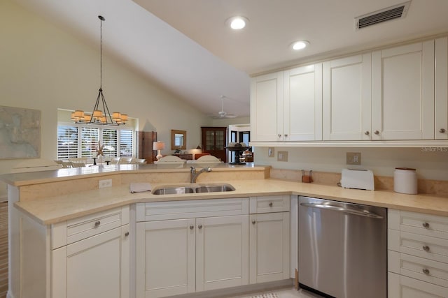 kitchen featuring sink, stainless steel dishwasher, kitchen peninsula, decorative light fixtures, and vaulted ceiling