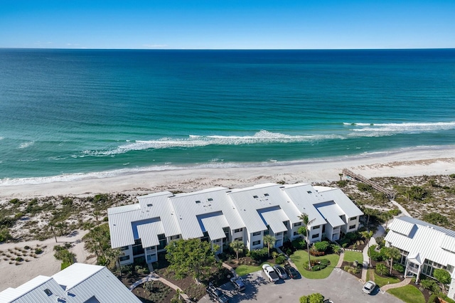 birds eye view of property with a beach view and a water view