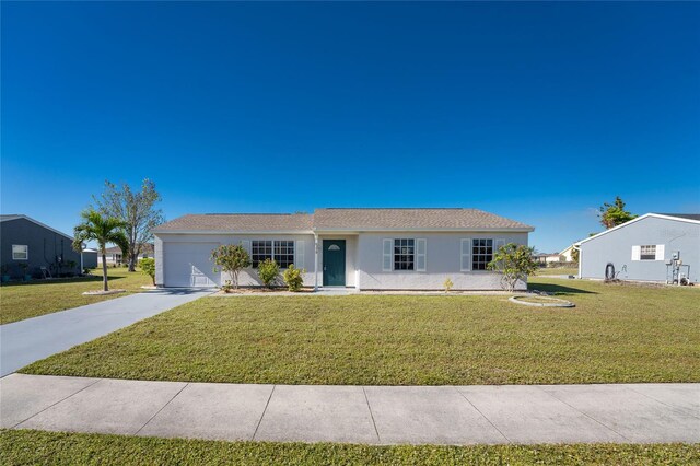 ranch-style home with a front lawn and a garage