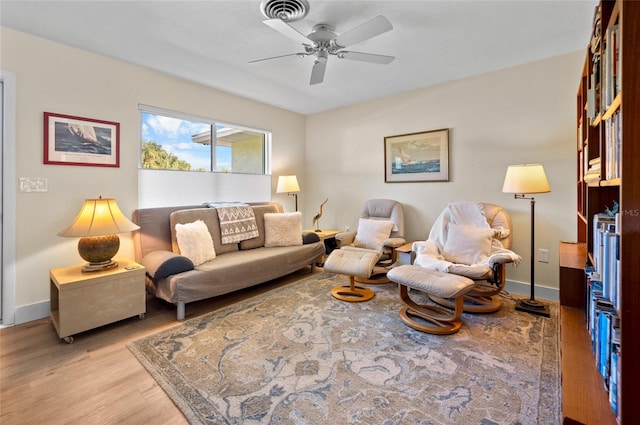 living room with ceiling fan and light wood-type flooring