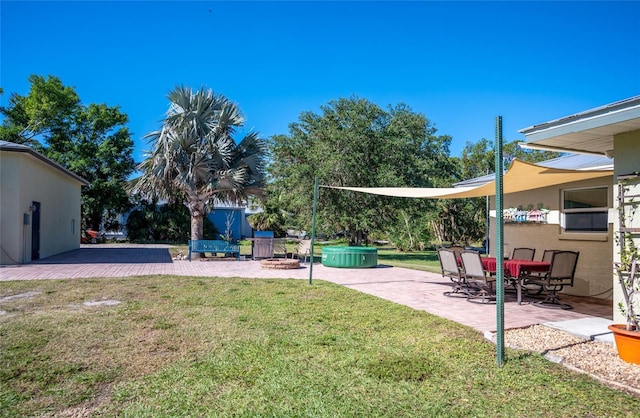 view of yard featuring a hot tub and a patio