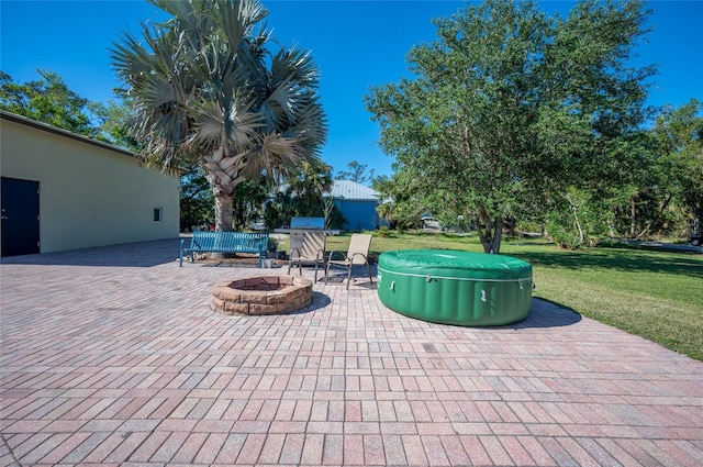 view of patio with a fire pit