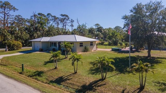 single story home featuring a garage and a front lawn