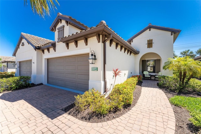 mediterranean / spanish house with a garage