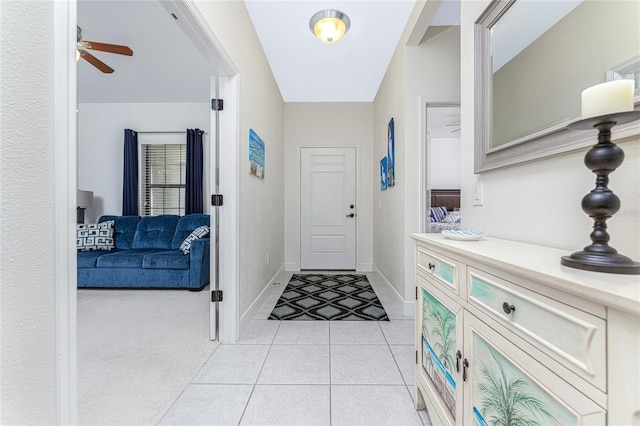 foyer entrance featuring ceiling fan and light tile patterned floors