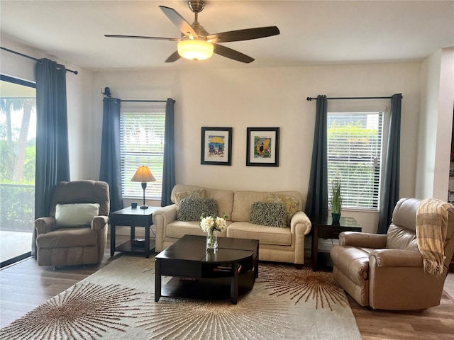 living room with hardwood / wood-style floors, ceiling fan, and a wealth of natural light