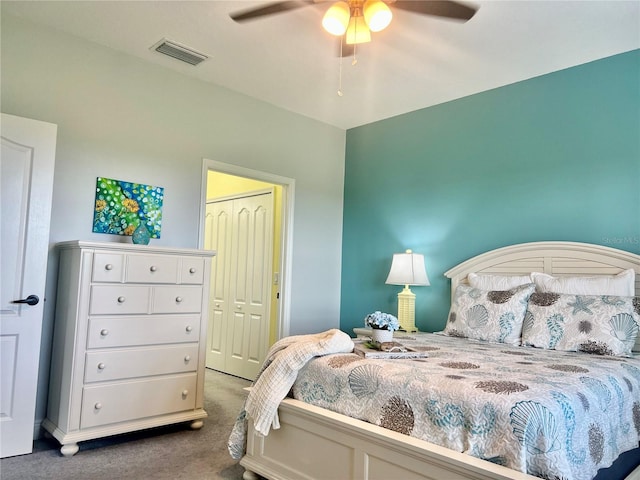 bedroom with dark carpet, a closet, and ceiling fan