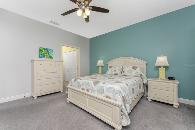 bedroom featuring ceiling fan, a closet, light carpet, and lofted ceiling