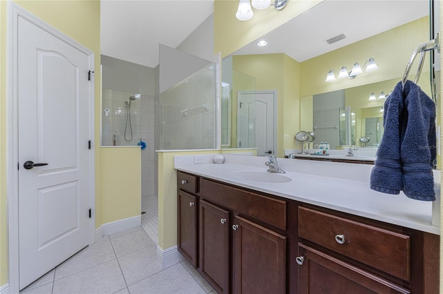 bathroom featuring tiled shower, vanity, and tile patterned floors