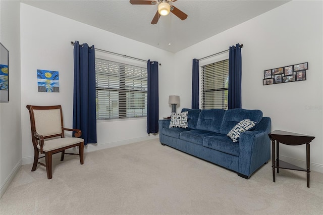 carpeted living room with ceiling fan, a healthy amount of sunlight, and a textured ceiling