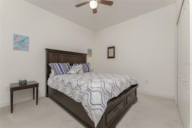 carpeted bedroom featuring a closet, vaulted ceiling, and ceiling fan