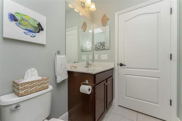 bathroom featuring tile patterned floors, vanity, and toilet