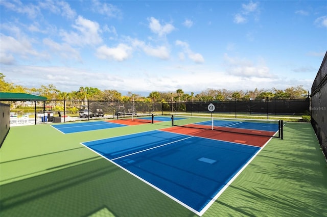 view of tennis court with basketball hoop