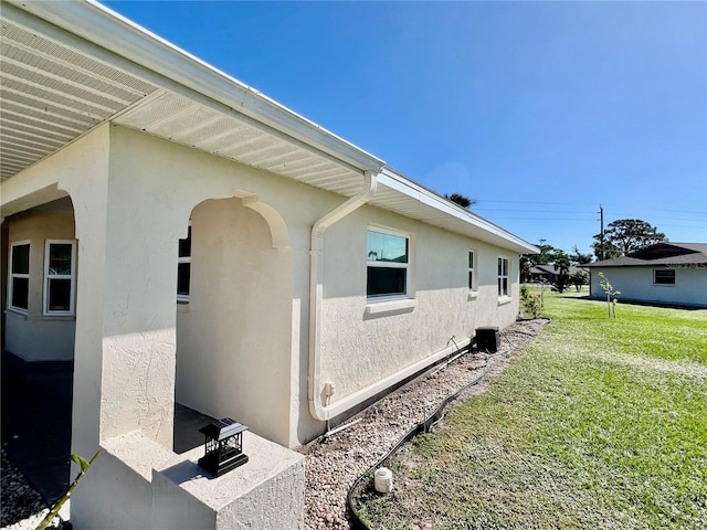 view of property exterior with a yard