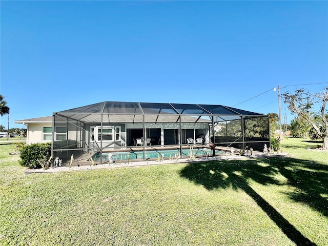 rear view of property featuring a lanai and a yard