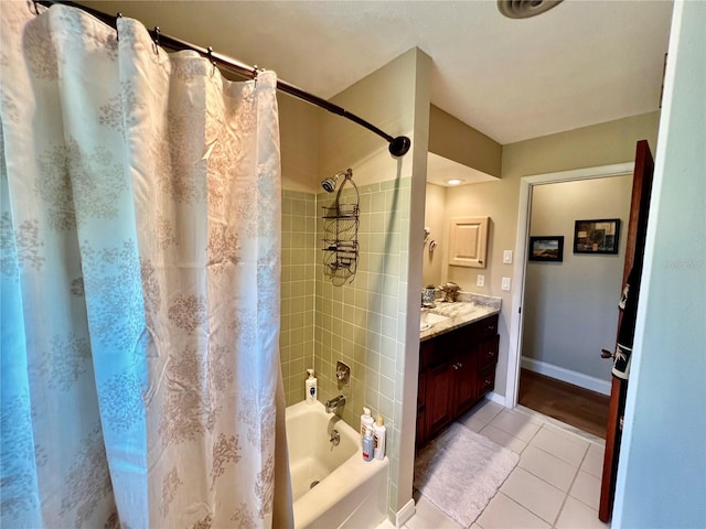 bathroom featuring tile patterned flooring, shower / bath combo, and vanity