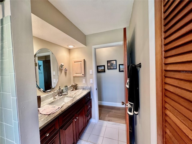 bathroom featuring tile patterned flooring and vanity