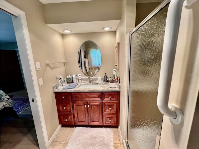 bathroom with tile patterned flooring, vanity, and a shower with door