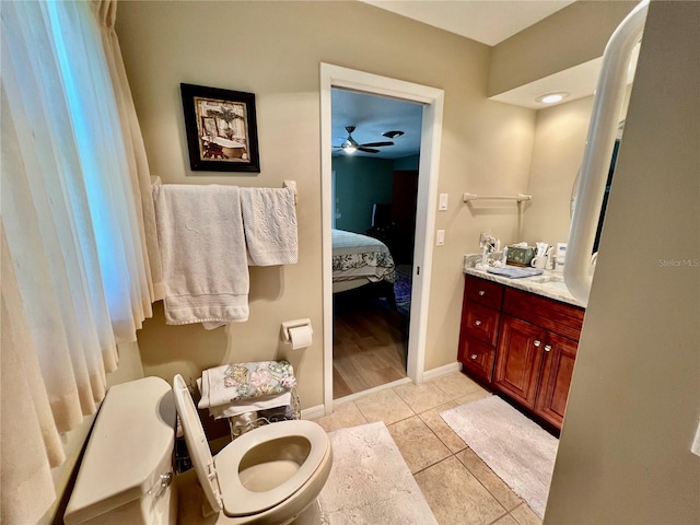 bathroom featuring ceiling fan, tile patterned flooring, vanity, and toilet