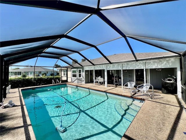 view of swimming pool with a patio and a lanai