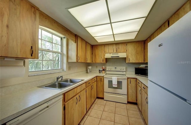 kitchen with sink, light tile patterned flooring, and white appliances