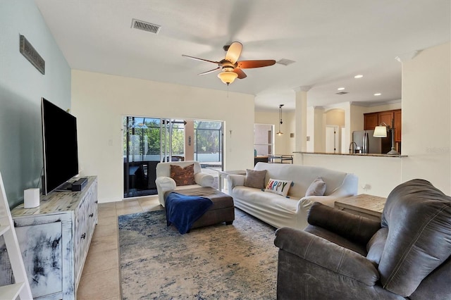 living room with ceiling fan and light tile patterned flooring