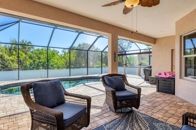 view of patio / terrace featuring ceiling fan, a fenced in pool, and glass enclosure