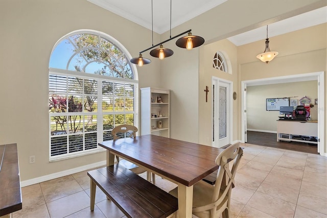 tiled dining space featuring ornamental molding