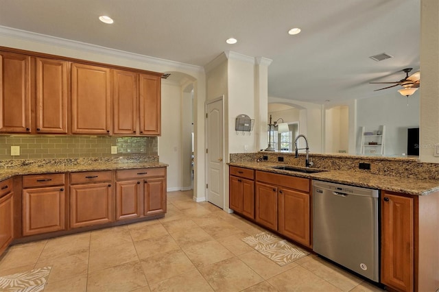 kitchen featuring stainless steel dishwasher, light stone counters, ornamental molding, ceiling fan, and sink