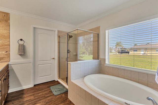 bathroom with shower with separate bathtub, vanity, ornamental molding, and wood-type flooring