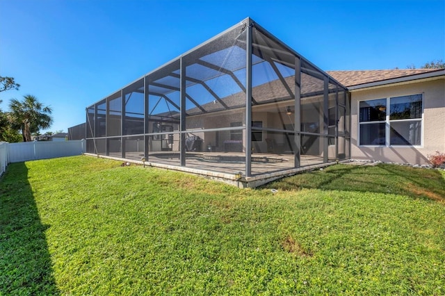 view of yard with glass enclosure and a patio