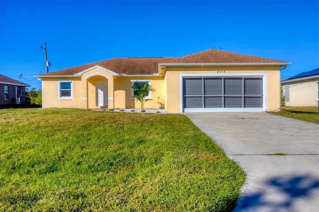 ranch-style house featuring a front yard and a garage