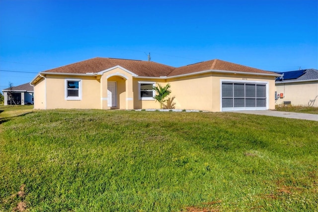 ranch-style home featuring a garage and a front lawn