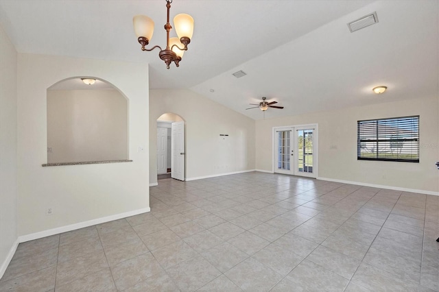 tiled empty room with ceiling fan with notable chandelier, lofted ceiling, and french doors