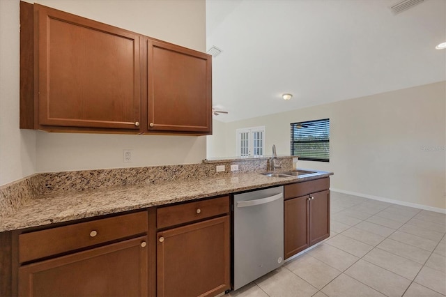 kitchen featuring light stone countertops, stainless steel dishwasher, ceiling fan, sink, and light tile patterned floors