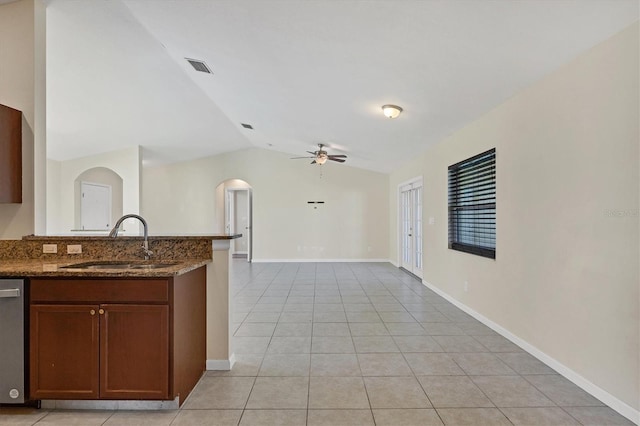 kitchen featuring dishwasher, lofted ceiling, sink, ceiling fan, and light tile patterned floors