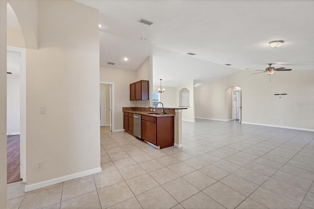 kitchen with dishwasher, sink, vaulted ceiling, ceiling fan, and light tile patterned floors