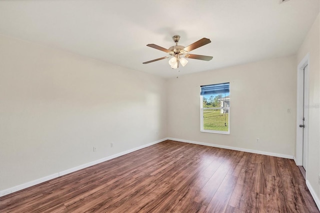 unfurnished room featuring ceiling fan and dark hardwood / wood-style flooring