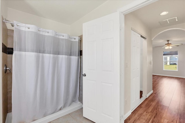 bathroom with wood-type flooring, ceiling fan, and lofted ceiling