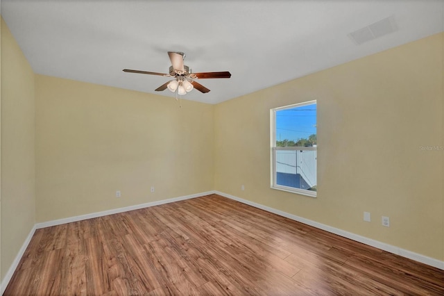 empty room featuring wood-type flooring and ceiling fan