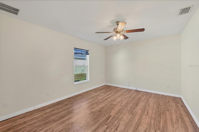 spare room with ceiling fan and wood-type flooring